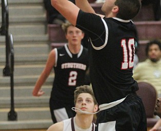 William D. Lewis The Vindicator Struthers AJ Musolino(10) shoots over Liberty's Kein Hawn(3).