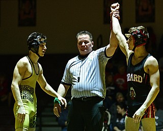LIBERTY, OHIO - FEBRUARY 15, 2017: Dakota McCluskey of Girard has his arm raised by the referee after defeating Ben Sattler of Liberty after their 120lb bout Wednesday night at Liberty High School. DAVID DERMER | THE VINDICATOR