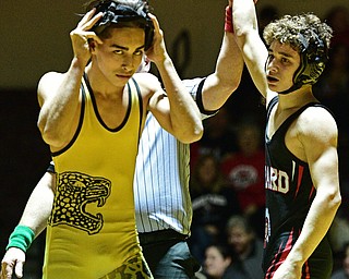 LIBERTY, OHIO - FEBRUARY 15, 2017: Matt Belcik of Girard has his arm raised by the referee while Hamad Alhmeed of Liberty takes off his head gear after being defeated after their 126lb bout during their 120lb bout Wednesday night at Liberty High School. DAVID DERMER | THE VINDICATOR