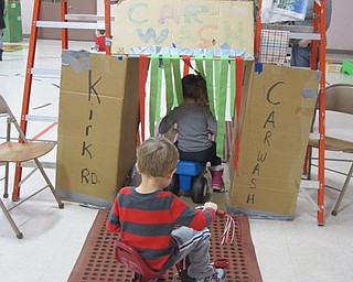 Neighbors | Alexis Bartolomucci.Children at The Growing Place in Austintown rode their bikes through the car wash that was set up during the St. Jude Trike-A-Thon on Jan. 31.