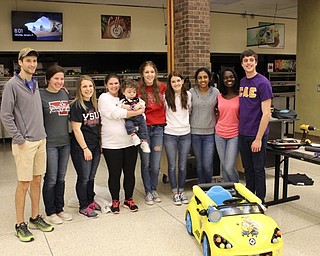 Neighbors | Abby Slanker.Team Matthew proudly showed off the “Minion” car, which they modified for Matthew (center) during the Go Baby Go build at the Mahoning County Career and Technical Center on Jan. 21.
