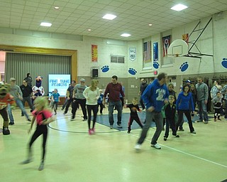 Neighbors | Alexis Bartolomucci.Poland Union first-grade students and their families did exercises across the gym during the Family Health Night on Jan. 25.