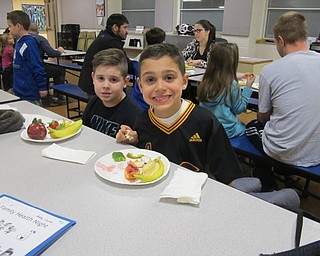 Neighbors | Alexis Bartolomucci.Bobby Canter and Colin Sacui enjoyed fresh fruit and veggies during the Family Health Night at Poland Union on Jan. 25.