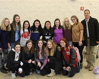 Neighbors | Abby Slanker.Members of the Canfield High School girls soccer team, along with head coach Phil Simone (right) attended senior Anita Mancini’s letter-of-intent signing ceremony during which she announced she will continue her soccer career at the University of Toledo on Feb. 1.