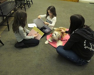 Neighbors | Alexis Bartolomucci.Kristina and Julia read stories they picked out to therapy dog Roxie on Jan. 31 at the Poland library.