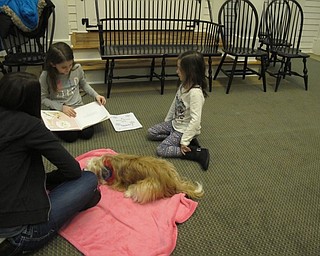 Neighbors | Alexis Bartolomucci.Kristina read a book she picked out to Roxie, a therapy dog, at the Poland library on Jan. 31.