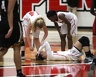 Youngstown State junior guard Indiya Benjamin(3)(right) and sophomore guard Melinda Trimmer(14)(left) check on teammate sophomore guard Alison Smolinski(2)(center) as she holds her head in pain during the 4th quarter as Northern Kentucky University takes on Youngstown State University, Thursday, Feb. 16, 2017 at the Beeghly Center at Youngstown State University. YSU won 77-73...(Nikos Frazier | The Vindicator)..