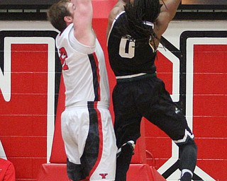 Wright State senior forward Steven Davis(0) goes up for a layup as Youngstown State Penguins senior center Jorden Kaufman(32) tries to block his shot during the 1st half as Wright State University takes on Youngstown State University, Thursday, Feb. 16, 2017 at the Beeghly Center at Youngstown State University. Wright State won 84-81...(Nikos Frazier | The Vindicator)..