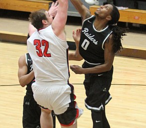 Youngstown State Penguins senior center Jorden Kaufman(32)'s layup is blocked by Wright State senior forward Steven Davis(0) during the 1st half as Wright State University takes on Youngstown State University, Thursday, Feb. 16, 2017 at the Beeghly Center at Youngstown State University. Wright State won 84-81...(Nikos Frazier | The Vindicator)..
