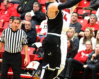 Youngstown State Penguins junior guard Cameron Morse(24) goes up for three as Wright State junior gurad Grant Benzinger(13) tries to block the shot during the 1st half as Wright State University takes on Youngstown State University, Thursday, Feb. 16, 2017 at the Beeghly Center at Youngstown State University. Wright State won 84-81...(Nikos Frazier | The Vindicator)..
