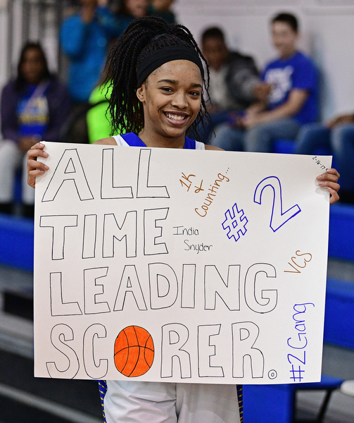 YOUNGSTOWN, OHIO - FEBRUARY 16, 2017: India Snyder #2 of Valley Christian holds up a poster made by her teammates as she celebrates her 1,000th career point after Wednesday night's game against Cleveland Central Catholic, on Thursday, Feb. 16, 2017. DAVID DERMER | THE VINDICATOR