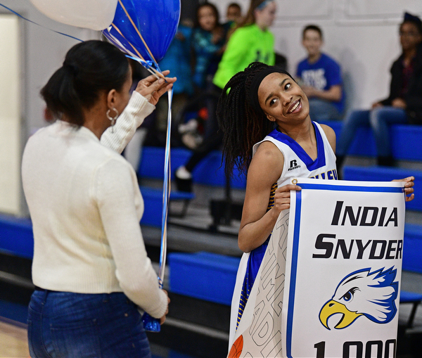YOUNGSTOWN, OHIO - FEBRUARY 16, 2017: India Snyder #2 of Valley Christian smiles while her mom Kim Snyder comes on the court to present her with some balloons as she celebrates her 1,000th career point after Wednesday night's game against Cleveland Central Catholic, on Thursday, Feb. 16, 2017. DAVID DERMER | THE VINDICATOR