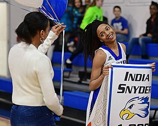 YOUNGSTOWN, OHIO - FEBRUARY 16, 2017: India Snyder #2 of Valley Christian smiles while her mom Kim Snyder comes on the court to present her with some balloons as she celebrates her 1,000th career point after Wednesday night's game against Cleveland Central Catholic, on Thursday, Feb. 16, 2017. DAVID DERMER | THE VINDICATOR