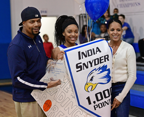 YOUNGSTOWN, OHIO - FEBRUARY 16, 2017: India Snyder #2 of Valley Christian smiles with her parents Antwon and Kim Snyder on the court of Valley Christian High School as she celebrates her 1,000th career point after Wednesday night's game against Cleveland Central Catholic on Thursday, Feb. 16, 2017. DAVID DERMER | THE VINDICATOR