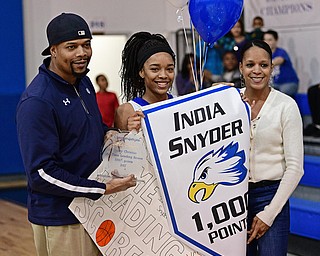 YOUNGSTOWN, OHIO - FEBRUARY 16, 2017: India Snyder #2 of Valley Christian smiles with her parents Antwon and Kim Snyder on the court of Valley Christian High School as she celebrates her 1,000th career point after Wednesday night's game against Cleveland Central Catholic on Thursday, Feb. 16, 2017. DAVID DERMER | THE VINDICATOR