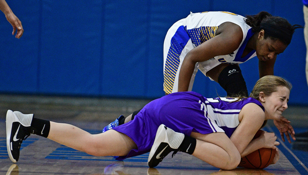 YOUNGSTOWN, OHIO - FEBRUARY 16, 2017: Joanna Bell #22 of Heartland dives to the floor to keep Asia Jones #1 of Valley Christian from gaining control of the ball during the first half of their game Thursday night at Valley Christian High School. DAVID DERMER | THE VINDICATOR