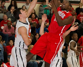 MICHAEL G TAYLOR | THE VINDICATOR- 02-17-17  -Basketball-  1st qtr., Labrae's #15 Carlton Brown scores over Howland's #33 Kevin Moamis.  Boys high School basketball Labrae Vikings vs Howland Tigers at Howland High School, Warren, OH