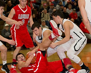 MICHAEL G TAYLOR | THE VINDICATOR- 02-17-17  -Basketball-  1st qtr., Labrae's #1 Mike Eakins (on floor)  battles for the loose ball with Howland's #33 Kevin Moamis. Boys high School basketball Labrae Vikings vs Howland Tigers at Howland High School, Warren, OH