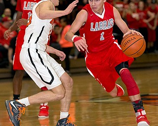 MICHAEL G TAYLOR | THE VINDICATOR- 02-17-17  -Basketball-  1st qtr., Labrae's #1 Mike Eakins drives against Howland's #13 Connor Tamarkin. Boys high School basketball Labrae Vikings vs Howland Tigers at Howland High School, Warren, OH