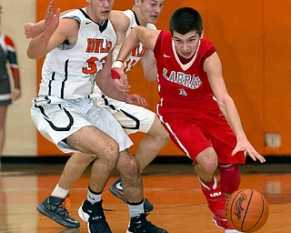 MICHAEL G TAYLOR | THE VINDICATOR- 02-17-17  -Basketball-  1st qtr., Labrae's #1 Mike Eakins drives by Howland's #13 Connor Tamarkin and #33 Kevin Moamis. Boys high School basketball Labrae Vikings vs Howland Tigers at Howland High School, Warren, OH
