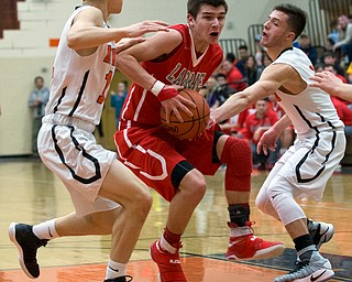 MICHAEL G TAYLOR | THE VINDICATOR- 02-17-17  -Basketball-  2nd qtr., Labrae's #1 Mike Eakins drives rto the hoop against Howland's #4 Nathan Leventis (reaching in from right) and Howland's #11 Jonah Weisman (left). Boys high School basketball Labrae Vikings vs Howland Tigers at Howland High School, Warren, OH
