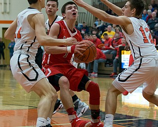 MICHAEL G TAYLOR | THE VINDICATOR- 02-17-17  -Basketball-  2nd qtr., Labrae's #1 Mike Eakins drives to the hoop against Howland's Howland's #11 Jonah Weisman (left) and #12 Michael Massucci. Boys high School basketball Labrae Vikings vs Howland Tigers at Howland High School, Warren, OH