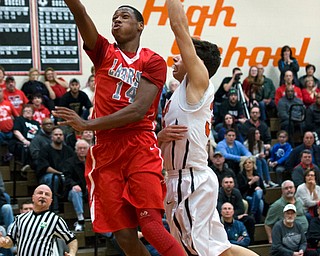 MICHAEL G TAYLOR | THE VINDICATOR- 02-17-17  -Basketball-  2nd qtr., Labrae's #14 Tariq Drake scores against Howland's #33 Kevin Moamis.  Boys high School basketball Labrae Vikings vs Howland Tigers at Howland High School, Warren, OH