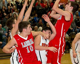 MICHAEL G TAYLOR | THE VINDICATOR- 02-17-17  -Basketball-  2nd qtr., Labrae's #1 Mike Eakins shoots against the defense of Howland's #3 Frank Rappach and Howland's #13 Connor Tamarkin. Also pictured, labrae's #10 Logan Giser Boys high School basketball Labrae Vikings vs Howland Tigers at Howland High School, Warren, OH