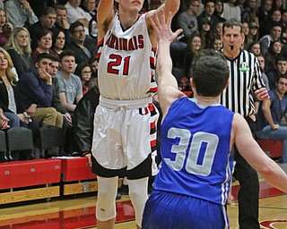 Canfield's Zach Tinkey (21) goes up for a 3-pointer while being defended by Kyle Patterson (30) during Friday nights matchup at Canfield High School.  Dustin Livesay  |  The Vindicator  2/17/17 Canfield High School.