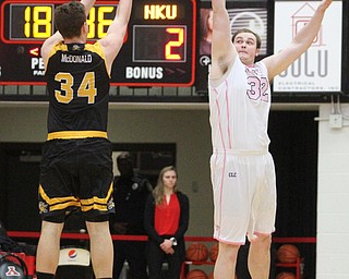 Northern Kentucky sophomore forward Drew McDonald(34) goes up for three as Youngstown State Penguins senior center Jorden Kaufman(32) tries to block his shot during the 1st half as Northern Kentucky takes on Youngstown State, Saturday, Feb. 18, 2017 at the Beeghly Center. Youngstown State won, 81-77...(Nikos Frazier | The Vindicator)..