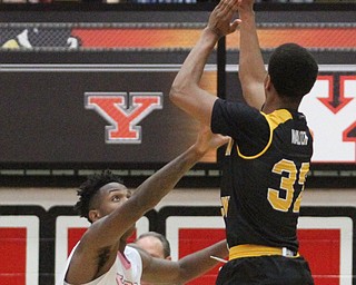 Northern Kentucky freshman guard Dantez Walton(32) goes up for three as Youngstown State Penguins freshman guard Braun Hartfield(1) tries to stop the ball during the 1st half as Northern Kentucky takes on Youngstown State, Saturday, Feb. 18, 2017 at the Beeghly Center. Youngstown State won, 81-77...(Nikos Frazier | The Vindicator)..