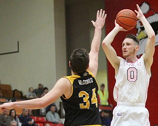 Youngstown State Penguins senior forward Matt Donlan(0) goes up for three as Northern Kentucky sophomore forward Drew McDonald(34) tries to block his shot during the 1st half as Northern Kentucky takes on Youngstown State, Saturday, Feb. 18, 2017 at the Beeghly Center. Youngstown State won, 81-77...(Nikos Frazier | The Vindicator)..
