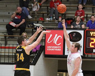 Northern Kentucky sophomore forward Drew McDonald(34) goes up for three as Youngstown State Penguins senior center Jorden Kaufman(32) tries to stop the shot during the 1st half as Northern Kentucky takes on Youngstown State, Saturday, Feb. 18, 2017 at the Beeghly Center. Youngstown State won, 81-77...(Nikos Frazier | The Vindicator)..