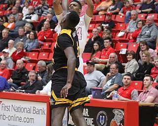Youngstown State Penguins junior guard Cameron Morse(24) jumps up for three as Northern Kentucky junior forward Jordan Garnett(1) tries to block his shot during the 1st half as Northern Kentucky takes on Youngstown State, Saturday, Feb. 18, 2017 at the Beeghly Center. Youngstown State won, 81-77...(Nikos Frazier | The Vindicator)..