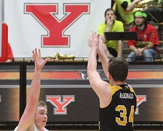 Northern Kentucky sophomore forward Drew McDonald(34) goes up for three as Youngstown State Penguins senior center Jorden Kaufman(32) tries to stop the shot during the 2nd half as Northern Kentucky takes on Youngstown State, Saturday, Feb. 18, 2017 at the Beeghly Center. Youngstown State won, 81-77...(Nikos Frazier | The Vindicator)..