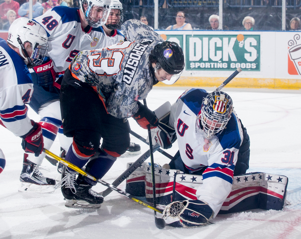 Scott R. Galvin | The Vindicator.Youngstown Phantoms forward Alex Esposito (23) battles for the puck with Team USA NTDP's goalie Ryan Ullan (310 during the first period at the Covelli Centre on February 18, 2017.