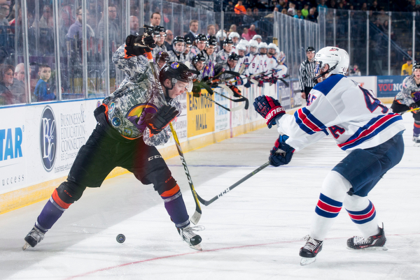 Scott R. Galvin | The Vindicator.Youngstown Phantoms forward Tommy Apap (21) battles with Team USA NTDP's DJ King for the puck during the second period at the Covelli Centre on February 18, 2017.