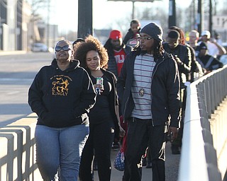 Councilman Julius Oliver(D-Youngstown Ward-1) and residents from the South Side walk down the Market St. Bridge during the Youngstown Peace Walk and Bonfire under the Market St. Bridge in downtown Youngstown, Sunday, Feb. 19, 2017. ..(Nikos Frazier | The Vindicator)..