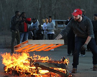 Mike McGiffin, Coordinator of Events & Special Projects for the City of Yougnstown, adds a fresh pallet to the bonfire during the Youngstown Peace Walk and Bonfire under the Market St. Bridge in downtown Youngstown, Sunday, Feb. 19, 2017. ..(Nikos Frazier | The Vindicator)..