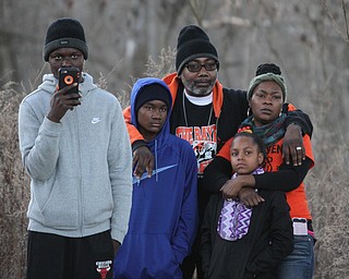 Jaray Jefferson, 17(left) takes a video with his phone as his family stands in the background during the Youngstown Peace Walk and Bonfire under the Market St. Bridge in downtown Youngstown, Sunday, Feb. 19, 2017. ..(Nikos Frazier | The Vindicator)..ID's: from left, Jaray Jefferson(17), Clemale Pinkard(12), Jason Pinkard, Keishawna Pruitt(10) and Shawnda Pinkard