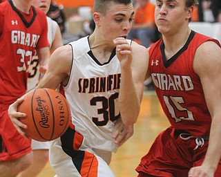 William D Lewis The Vindicator Springfield's JAke Ford(30) drives past Girard's Mark Waid (15) during Feb 20, 2017 action at Springfield.