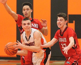 William D Lewis The Vindicator Springfield's JAke Ford(30) passes aroundGirard's Anthony Backus(3 ) and Austin O'Hara(33) during Feb 20, 2017 action at Springfield.