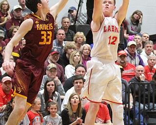 Andrew Hankins(12) of LaBrae goes up for three as Anthony Ritter(33) of South Range tries to block his shot during the 3rd quarter as South Range takes on LaBrae, Tuesday, Feb. 21, 2017 at LaBrae High School in Leavittsburg. LaBrae won 55-50...(Nikos Frazier | The Vindicator)..