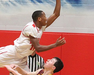 Tariq Drake(14) of LaBrae goes up for a layup as he falls onto Daniel Ritter(11) of South Range during the 4th quarter as South Range takes on LaBrae, Tuesday, Feb. 21, 2017 at LaBrae High School in Leavittsburg. LaBrae won 55-50...(Nikos Frazier | The Vindicator)..