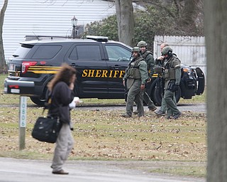        ROBERT K. YOSAY  | THE VINDICATOR..SWAT team leaves the house..GOSHEN Ñ Mahoning County Sheriff Jerry Greene said a suspect is dead from "apparent suicide" after shots were fired as deputies tried to serve a civil order of protection at about 11:20 a.m... .-30-