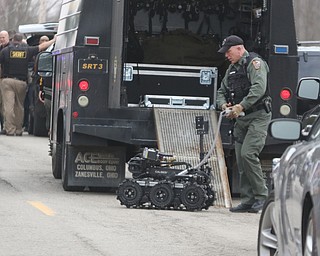        ROBERT K. YOSAY  | THE VINDICATOR..OSP  brings in the robot.. that eventually entered the house and found the suspect in the doorway..GOSHEN Ñ Mahoning County Sheriff Jerry Greene said a suspect is dead from "apparent suicide" after shots were fired as deputies tried to serve a civil order of protection at about 11:20 a.m... .-30-