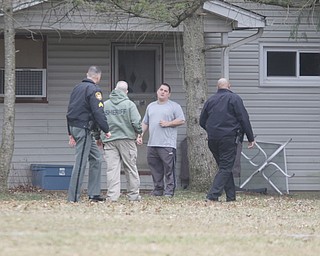        ROBERT K. YOSAY  | THE VINDICATOR..Sheriff Deputy's talk to a neighbor as they cleared the area directly around the house..GOSHEN Ñ Mahoning County Sheriff Jerry Greene said a suspect is dead from "apparent suicide" after shots were fired as deputies tried to serve a civil order of protection at about 11:20 a.m... .-30-