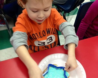 SPECIAL TO THE VINDICATOR
Students in Barbara Conti’s Preschool Enrichment class at Ursuline Preschool and Kindergarten recently learned about the winter habits of wild animals. Kyle Tobey, above, participated by preparing a special formula to feed birds.
