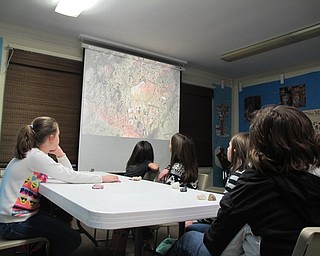 Neighbors | Alexis Bartolomucci.Children at the Geology Rocks program at Ford Nature Center on Feb. 4 looked at different types of rocks under a microscope projected onto a large screen.