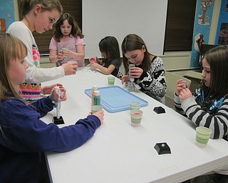 Neighbors | Alexis Bartolomucci.The children made sand art with different colored sand and different shaped molds at the Geology Rocks program at Ford Nature Center on Feb. 4.